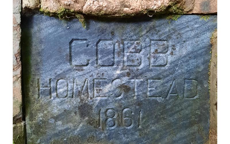 Photos by Bill Belian/ Contributing Photographer The Cobb Family plaque on the family’s old water well dates back to 1861, when Ty Cobb’s grandparents owned the local property.