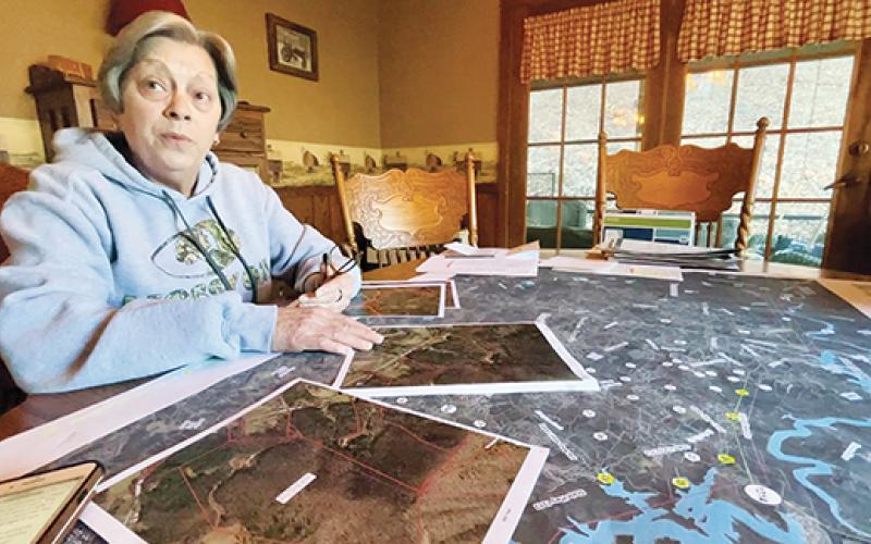 Randy Foster/editor@cherokeescout.com  Becky Wright has turned her dining room table into a project space in her fight against the Tennessee Valley Authority’s plans to install power transmission lines in western Cherokee County, including the Bell Hill Road property where she lives.
