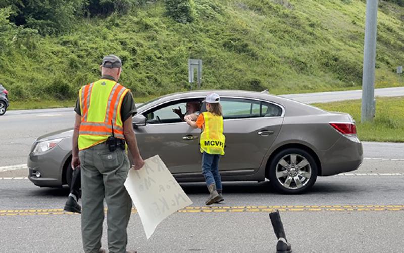 Abigail Blythe Batton/Staff Correspondent Martins Creek Fire Department Capt. Michael Carter and Dawson Lance collect donations during a boot drive Saturday at U.S. 64 and Old U.S. 64 in Brasstown.