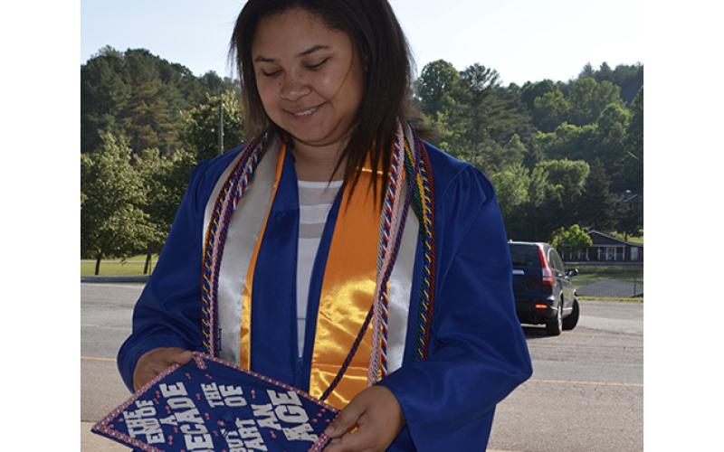 Photos by Abigail Blythe Batton/ Staff Correspondent Magna cum laude senior Kara Penland admires her cap during Saturday morning’s Hiwassee Dam High School Class of 2023 graduation. She took the quote, “The end of the decade, the start of an age,” from a Taylor Swift song.