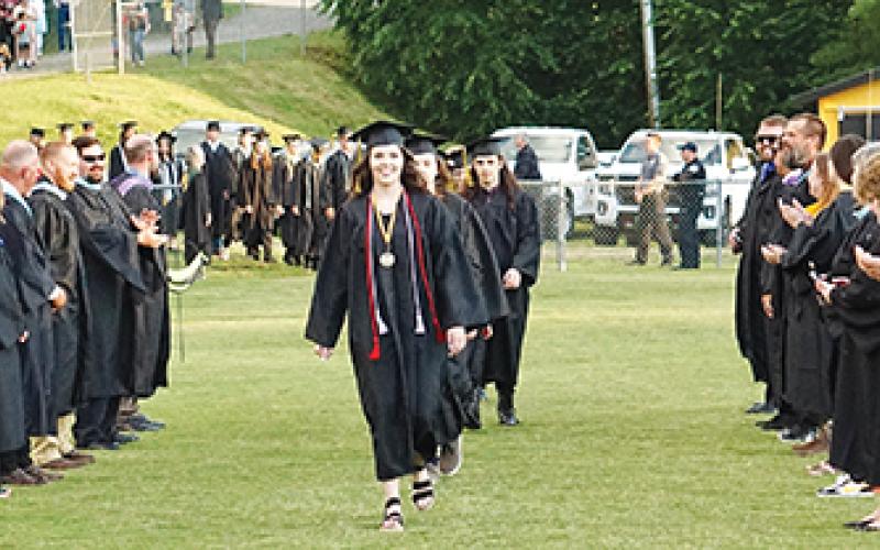 Photos by Randy Foster/editor@cherokeescout.com Graduating seniors, cheered on by Murphy High School’s faculty and staff, make their way onto David Gentry Field at Bob Hendrix Stadium during Friday night’s commencement.