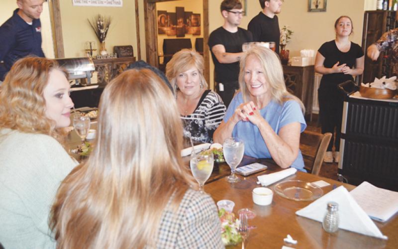 Abigail Blythe Batton/Staff Correspondent Exit Realty broker Kathy Vetton speaks with her team of real estate agents during the Mountain Lakes Board of Realtors meeting May 16 at Legends Steak House in Murphy.