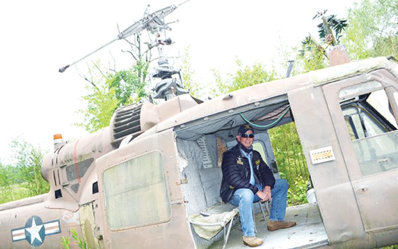 Abigail Blythe Batton/Staff Correspondent Dave “Scout” Nelson sits in the back of a UH-1 Iroquois helicopter at Roger Swanson’s Band of Brothers Veterans Park in Murphy.