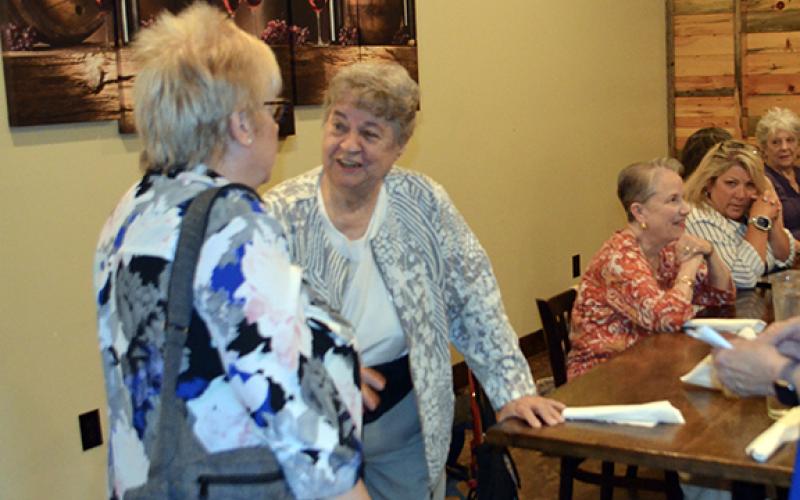 Abigail Blythe Batton/Staff Correspondent Karen Borchers, executive director of the United Way, greets a guest during her retirement dinner at Legend’s Steakhouse in Murphy on Thursday night.