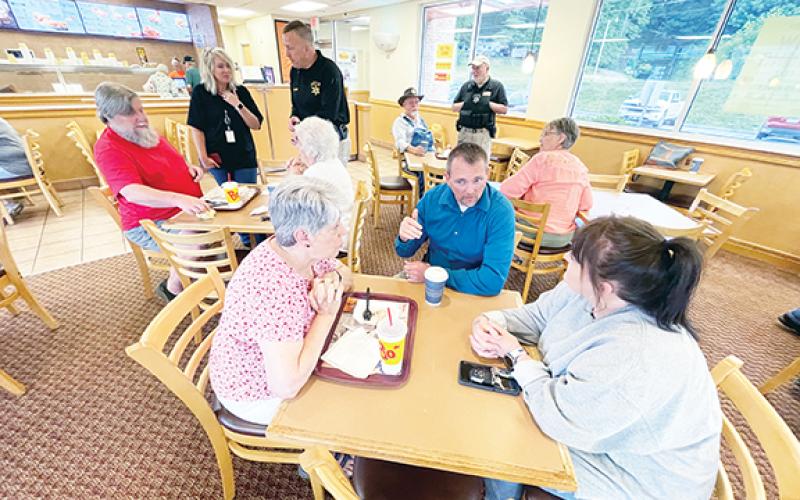 Randy Foster/editor@cherokeescout.com Suzi Perkins, Cherokee County Sheriff Dustin Smith and Kadee Close (from left) chat over coffee during a Coffee with a Cop event at Bojangles in Murphy on Friday.