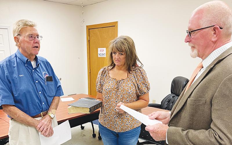 Board of Elections Chair Gary Kilpatrick (left) takes the oat of office over a Bible held by Director of Elections Leighsa Jones and administered by Cherokee County Clerk of Court Roger Gibson at the Board of Elections offices in Murphy on July 18.
