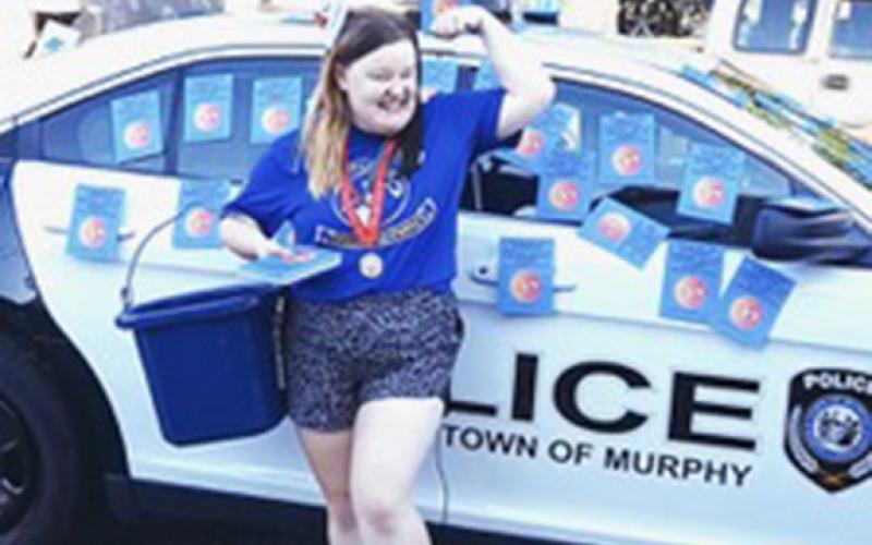 Lana Foster shows muscle in her ability to collect donations for the equestrian team seeking to attend the N.C. Special Olympic games in September of this year.