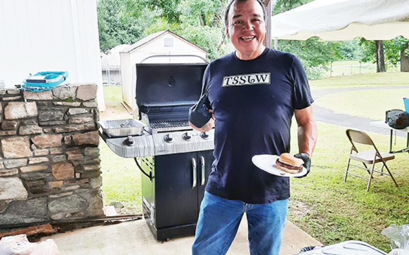 Anngee Quinones-Belian/ Staff Correspondent  Well-known James “Bo” Taylor, a Cherokee dancer and storyteller, was also busy grilling burgers and hot dogs during the health fair at the Marble Community Center on Thursday.