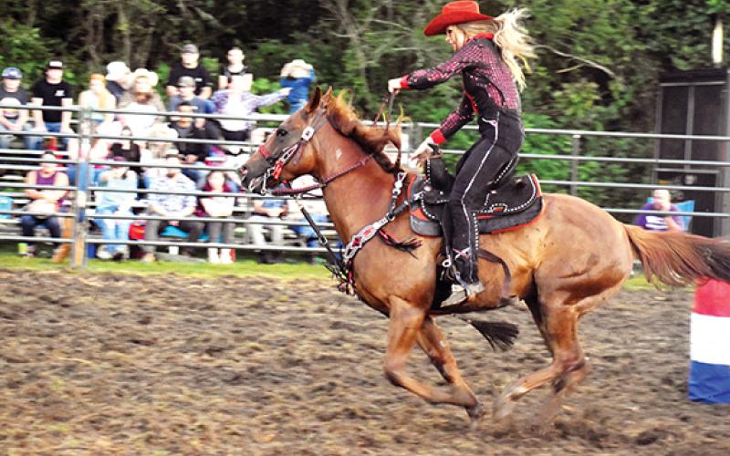  Kristen Miller directs her horse through the cowgirl barrel racing at Andrews Recreation Park. Event organizers hope to come back to town next year.