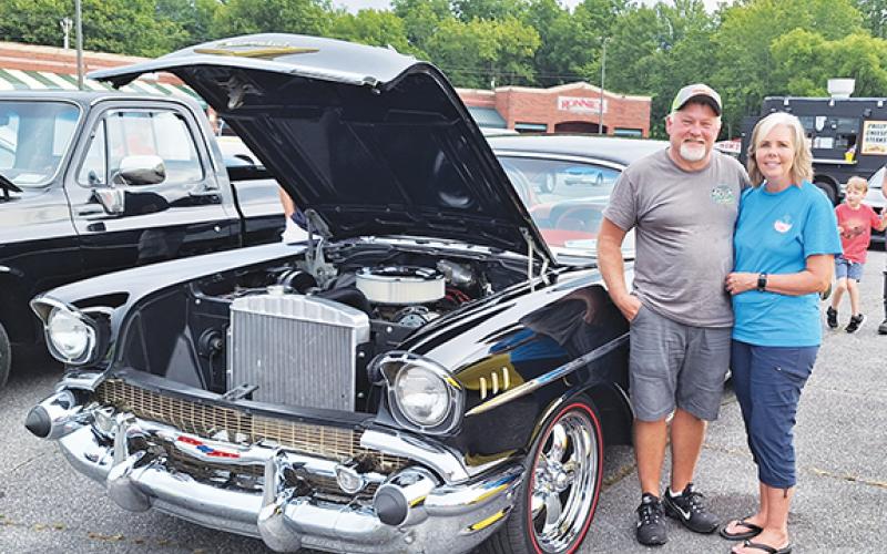 Photos by Bill Belian/Contributing Photographer Scott and Angie Dockery won a trophy for “Top 15” with their 1957 Chevy Bel Air. Happy to be at the Hot Summer Nights Cruise-in under rainy skies in Andrews, Scott said, “It takes five hours to wash, dry and shine it, but we’re happy to help the veterans.”