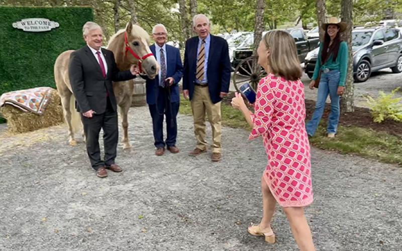 State Treasurer Dale Folwell, Cherokee County Commissioner Cal Stiles and former state Rep. Roger West (from left) pose with a horse before dinner at the Cherokee County Chamber of Commerce’s annual dinner Thursday evening. The horse, named Daniel, is a therapy horse from High Lonesome Therapeutic Equestrian Center in Ogreeta. Taking their photo is Synthia Folwell, Dale Folwell’s wife.