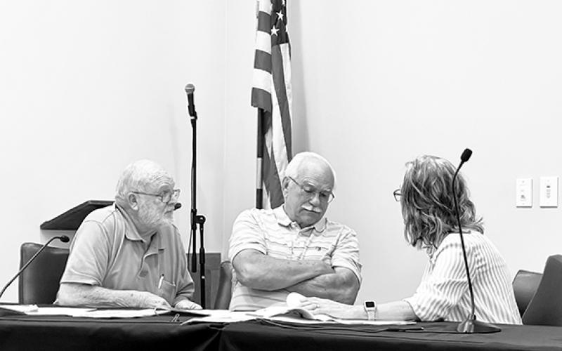 Randy Foster/editor@cherokeescout.com Jerry Decker, Alex Starks and Teresa Oblenes (from left), members of the Cherokee County Board of Equalization & Review, huddle to discuss an appeal of a $488 tax bill against Joe and Cherokee County Commissioner Jan Griggs at the county court house on Sept. 7.