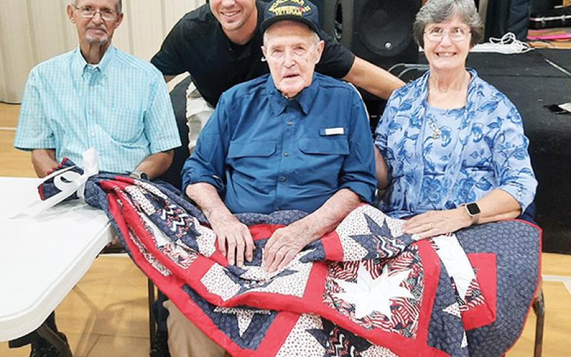 Photos by Anngee Quinones-Belian/Staff Correspondent  Family members accompany 98-year-old U.S. Army veteran Ralph Myers to a ceremony in his honor. Myers also received a quilt made by Susan Roper in appreciation for his service. From left are Dennis Myers, Andrew Brown, Ralph and Becky Brown.