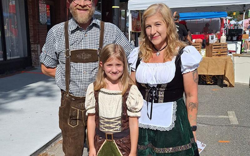 Bill Belian/Contributing Photographer Tim and Elizabeth Comstock and their daughter Ellie of Nantahala were at the Andrews Oktoberfest on Saturday wearing authentic Alpine garb.