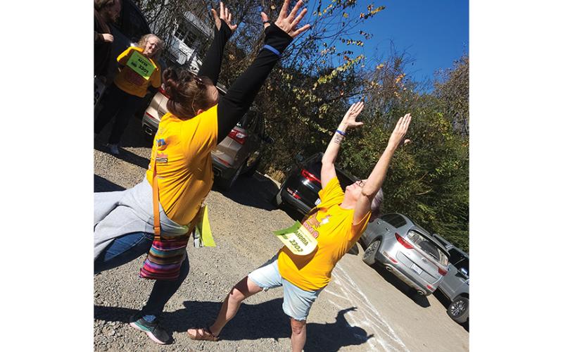 Stacy Warnock and Andria Overstreet “stretch” before “running” the Gobble Gallup on Saturday afternoon.