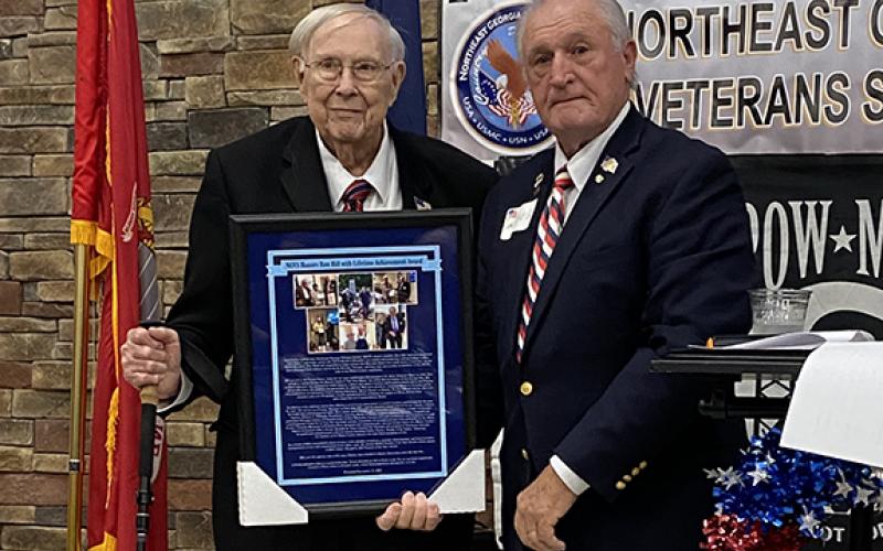 Ron Webb, president of the Northeast Georgia Veterans Society, presents a Lifetime of Service Award to Ron Hill (left) for his military service in three wars, civic service and service to other veterans over the last 70 years. Hill is a former local resident and Cherokee County manager.