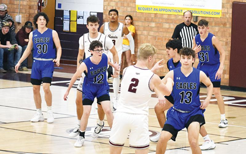 Photos by April McNabb/Contributing Photographer The Hiwassee Dam basketball teams split with Swain County on Dec. 5. The Lady Eagles beat the Maroon Devils 48-45, while the boys team lost 66-52.