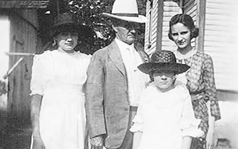 Olive is pictured with her father and her two sisters. From left are Olive; her father, John; Leuna; and Mary in the front.