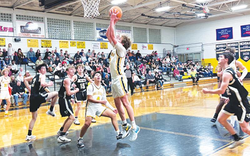 J.R. Carroll/Staff Correspondent Murphy’s Hunter Carson goes up for a score as Xander Wachacha looks on Feb. 13.