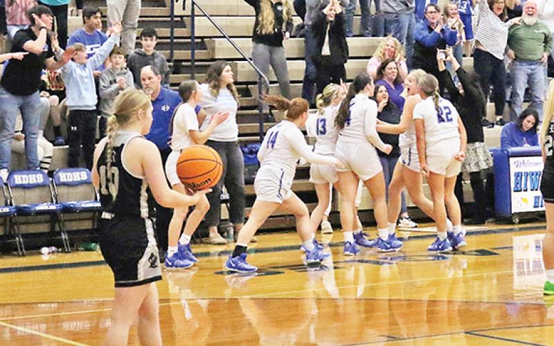 The Lady Eagles celebrate their buzzer-beater victory Thursday against Robbinsville.