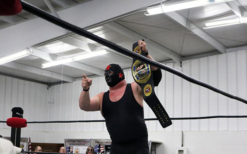 Mr. Atlanta No. 2 holds his ACWF heavyweight championship belt up