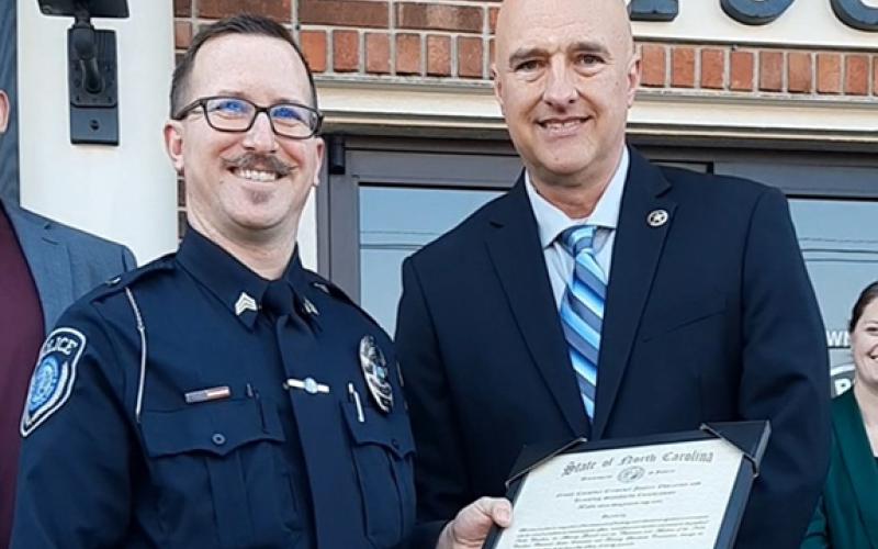 Anngee Quinones-Belian/Staff Correspondent  Sgt. Adam May accepts the Advanced Law Enforcement Certificate from Murphy Police Chief Tim Lominac during the department’s open house Thursday. May received the certificate for his years of experience and training hours.