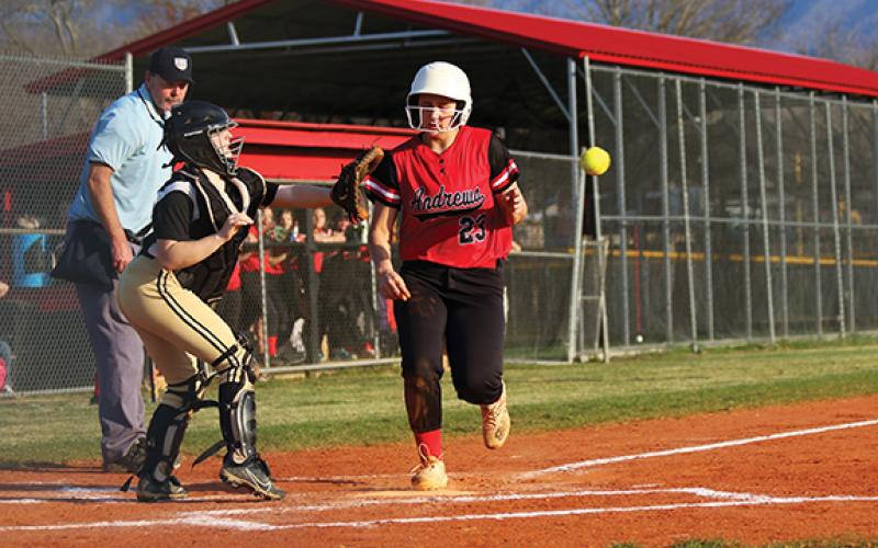 Trinity Taylor makes it home just before the catcher gets the ball to score for the Lady Wildcats during their late rally Thursday. It just wasn’t enough.
