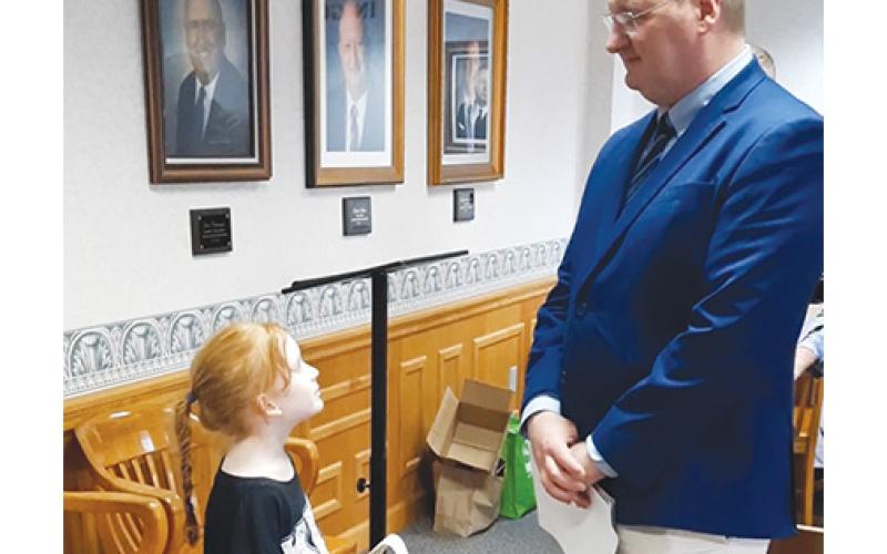 Peachtree Elementary School student Kadence Tanner looks up to Mayor Tim Radford during the Read Across America kickoff event at Murphy City Hall on Thursday.