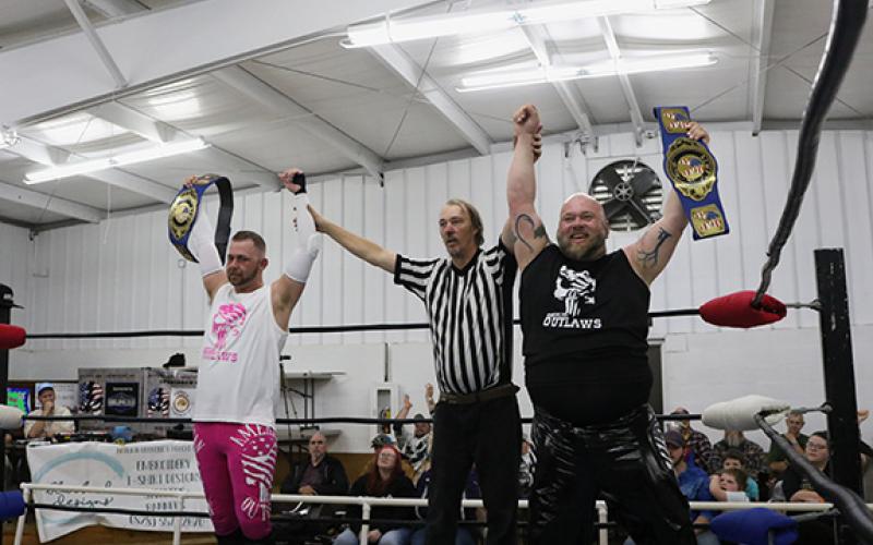 The American Outlaws with their hands raised after successfully defending their ACWF tag team championships.