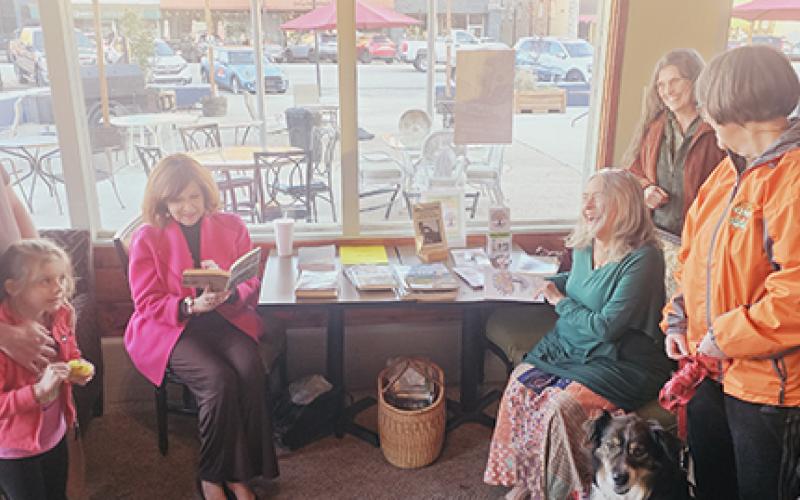 Nicole Wright/Staff Correspondent From left are Jonathan Cunningham and daughter Isabella, author Mary Jo Dyre, author Mary Ricketson, artist Pam Strawn and Kathy Dudek with dog Tishna at Cherokee Cellars in Murphy on March 28.