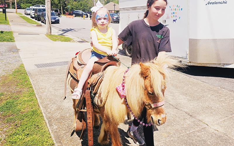 Nicole Wright/Staff Correspondent Miss Adelaide enjoys a turn with Little Rascals Pony Rides during the Spring Fling in Andrews while visiting with her grandparents.