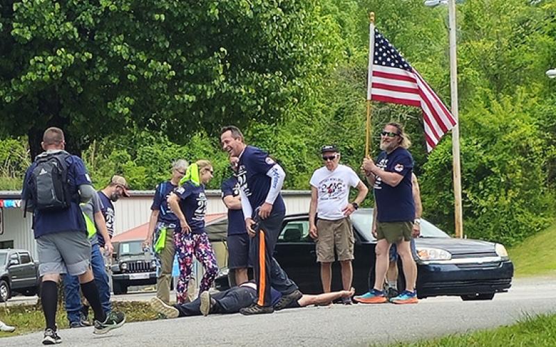 Nicole Wright/Staff Correspondent The 22-Humpers take a final break at the Hiwassee Street Boat Ramp on Saturday at Warriors Veteran Outreach’s 10th annual event to raise awareness for veterans’ suicides.