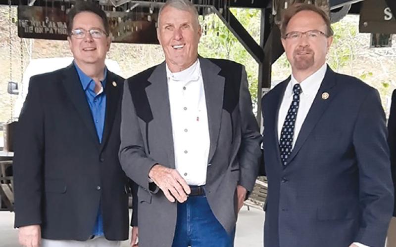 Anngee Quinones-Belian/Staff Correspondent Roger Swanson received the Purple Heart for his military service that resulted in injury in 1969 at Band of Brothers Veteran Park in Murphy on Friday. From left are state Sen. Kevin Corbin (R-Franklin), Swanson and U.S. Rep. Chuck Edwards (R-N.C.).