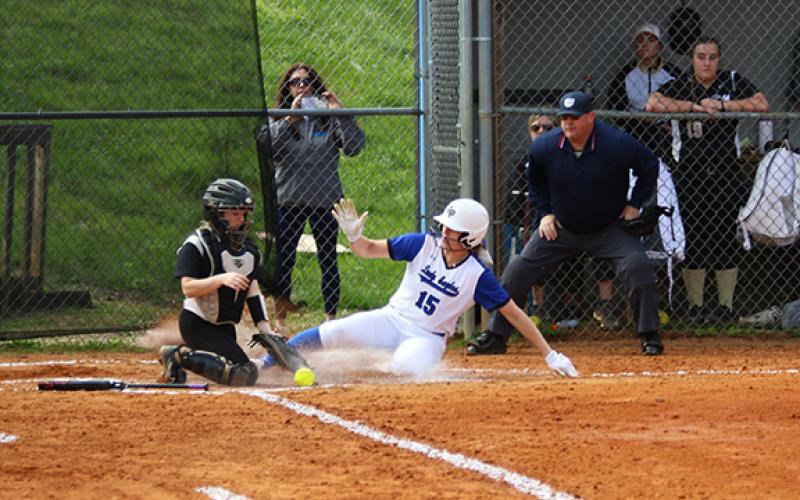 Cannon Crompton/sports@cherokeescout.com:  Olivia McNabb slides into home plate before the tag can be made on March 27. 