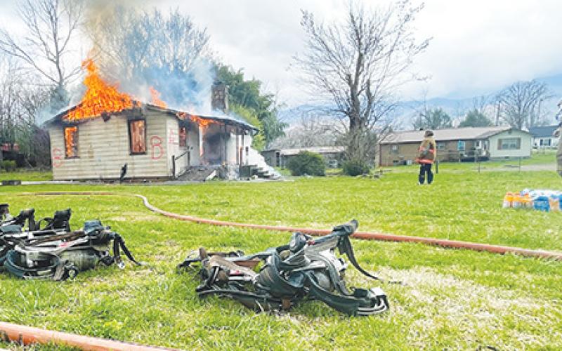 Valleytown Fire & Rescue volunteers conduct a training exercise at a home off of Walker Street in Andrews on Saturday. The training provides an opportunity for volunteers to train with a real-world structure fire under controlled conditions.
