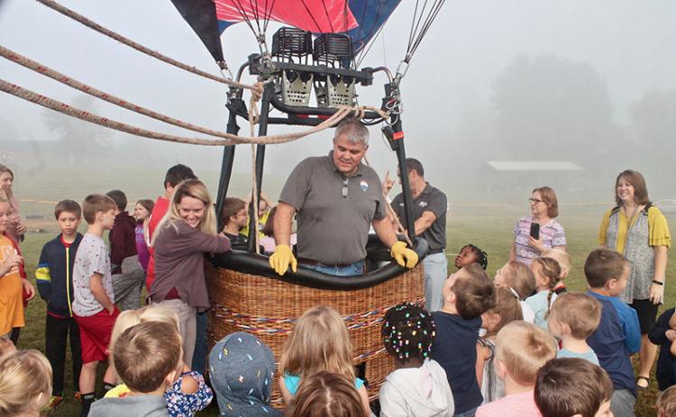 Tom Lattin shows local kids how to operate the Re/Max balloon in a demonstration Monday morning. Photo by Autumn Ritz