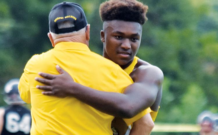 Devonte Murray and Coach David Gentry share an embrace before Murphy’s season-opening win against Pisgah.