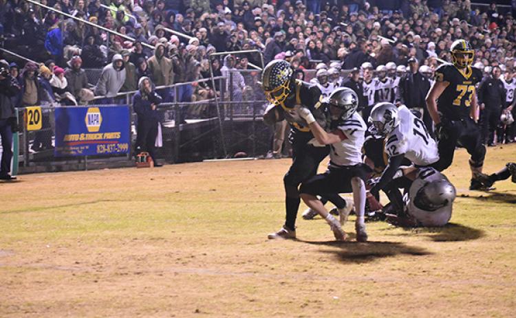 Murphy's Devonte Murray drags a Robbinsville defender into the end zone Friday night in the Bulldogs' loss to the Black Knights. 