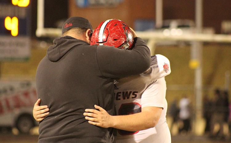 Mary White/Contributing Photographer: Senior Brawley Stillwell and Andrews head coach James Phillips share a moment following the Wildcats’ second-round loss to the second-seeded Elkin Elks.