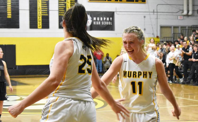 Murphy’s Torin Rogers (11) emphatically celebrates an and-one layup by Sarah Pullium (25) in the Lady Bulldogs’ dominant win against Hayesville. Photo by Noah Shatzer