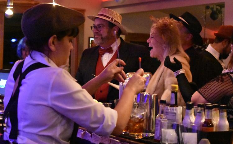 Greg and Beth Fidler of Warne enjoy celebrating at The Crown Brasstown as Andrea Garmon mixes drinks. Photo by Samantha Sinclair