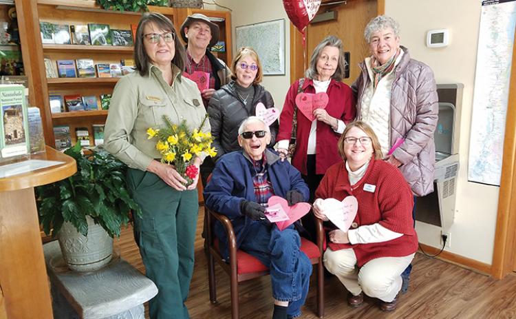 On behalf of the U.S. Forest Service, public affairs officer Cathy Dowd accepted valentines from Frank Landis, Mary Lightner, Lorraine Bennett, Mary Jo Dent, (seated), Tom Bennett and Callie Moore. Photo by Samantha Sinclair