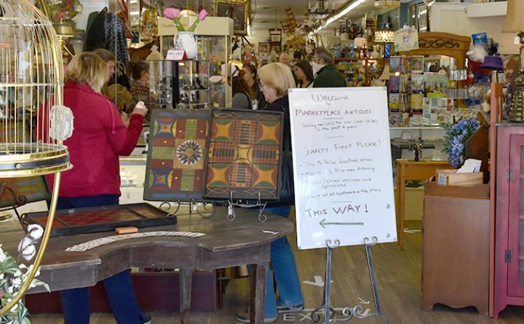 Shoppers followed directions for social distancing as they shopped at Marketplace Antiques on Saturday, the first full day non-essential businesses could open in the state. Photo by Noah Shatzer