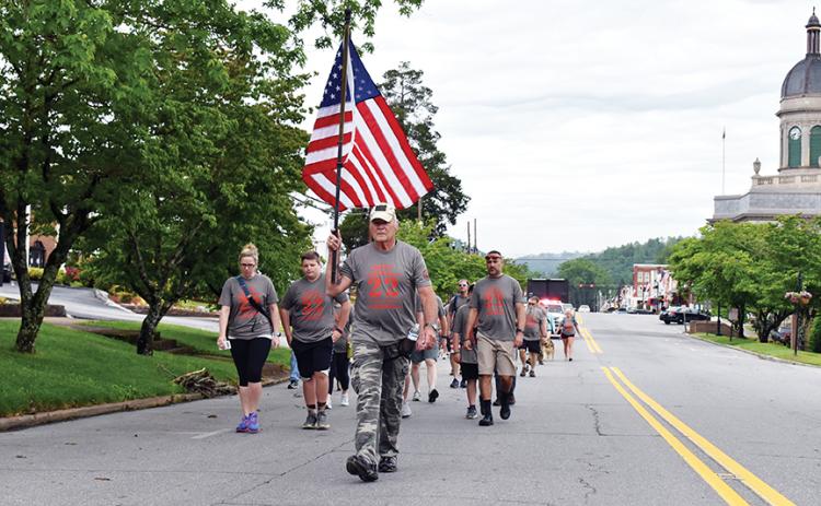 U.S. Air Force veteran Mark Narcowitz leads the procession of 22 Hump walkers down Peachtree Street in Murphy on the morning of May 23. Photo by Noah Shatzer