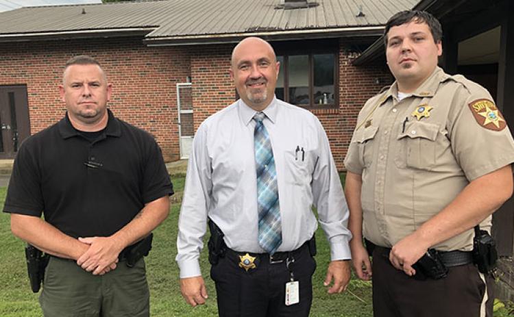 From left are Andrews police Officer Joseph Jones, Cherokee County Sheriff Derrick Palmer and Deputy Patrol Officer Coyle Olsen.