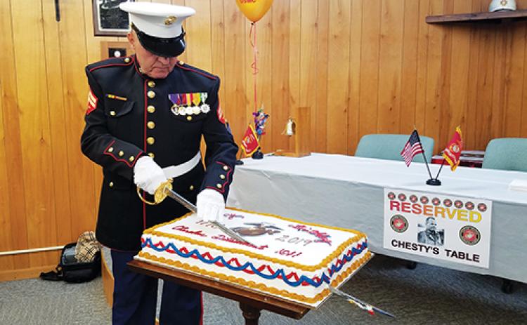 Samantha Sinclair/scoutingaround@cherokeescout.com Bob Lewis, junior vice commandant of the Marine Corps League, Cherokee Detachment 1011, cuts the birthday cake during last year’s birthday celebration.