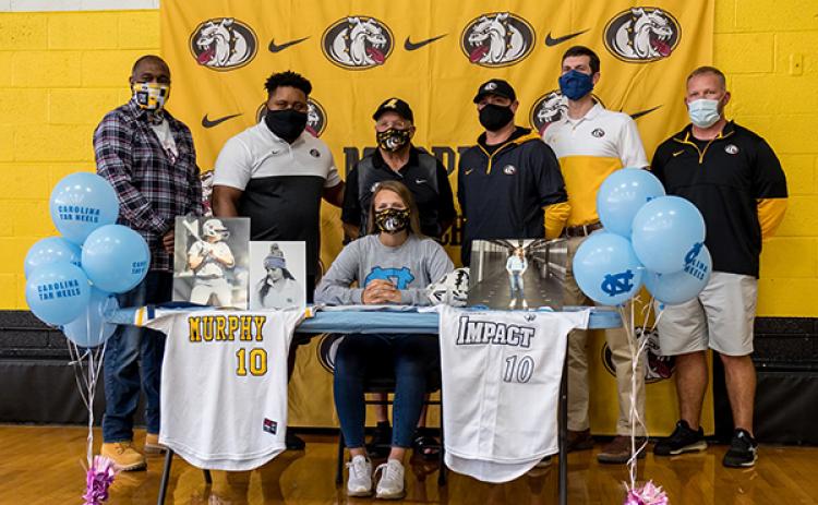 Murphy senior Annie Kate Dalton signed her letter of intent to play collegiate softball at the University of North Carolina in Chapel Hill on Thursday. Dalton, who will be kicking for the football team this season, was joined by coaches (from left) Mark Pickens, Thomas Nelson, David Gentry, Joseph Watson, Will Posey and Erik Laney.
