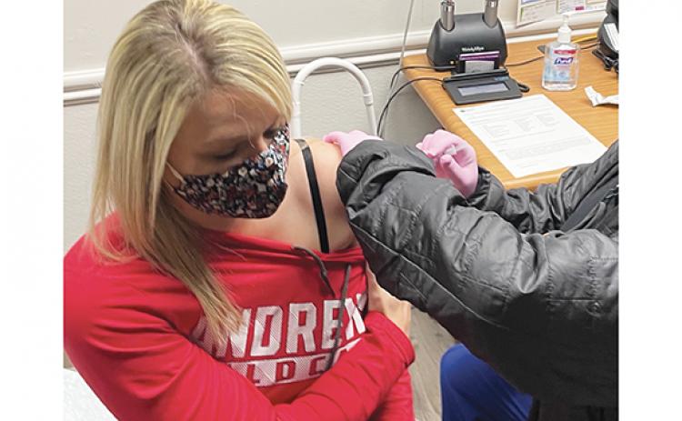Lindsey Roberts, a nurse at the Cherokee County Health Department, receives the first COVID-19 vaccination in the county. Nurse Misty Postell administered the vaccine on Dec. 23.
