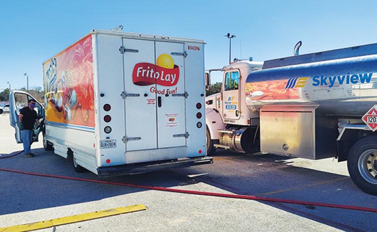 Skyview Energy driver Allen Crisp fills a Frito-Lay employee’s vehicle in Pharr, Texas.