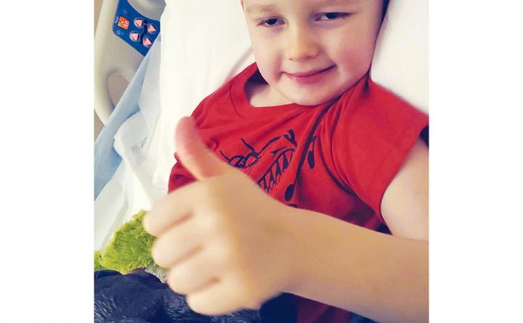 Ami Wilson/Contributing Photographer Dallas Wilson, 3, of Brasstown, suffered severe brain injuries in a freak accident on Jan. 27. He has made a miraculous recovery while still giving his signature thumbs-up.